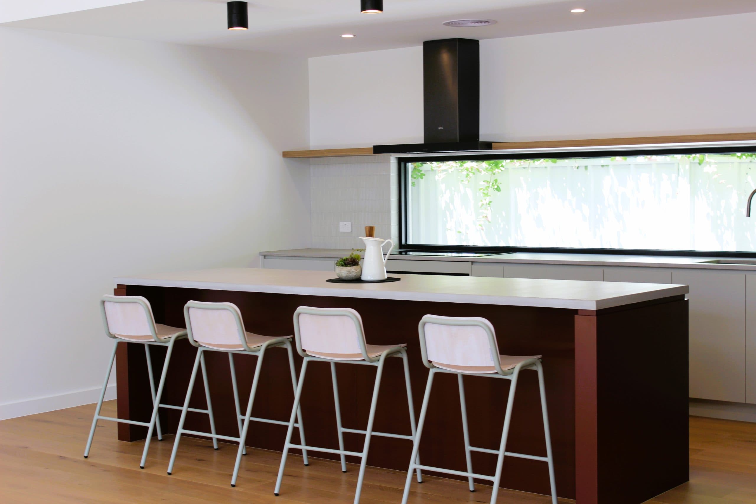 Modern kitchen renovation in Canberra, Australia with sleek island and natural light.